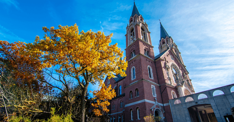 The Historic Stone Tower Stands Tall Above The Treetops